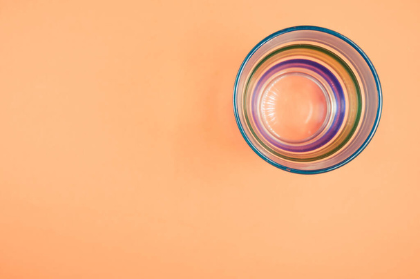 A top view of colored glass isolated on an orange background - Fotoğraf, Görsel