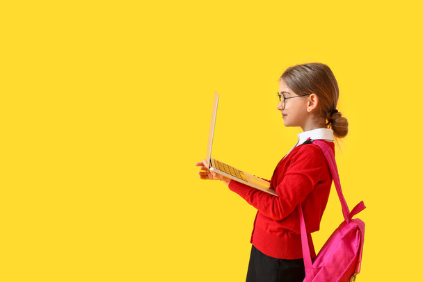 Söpö pieni koulu tyttö laptop väri tausta - Valokuva, kuva