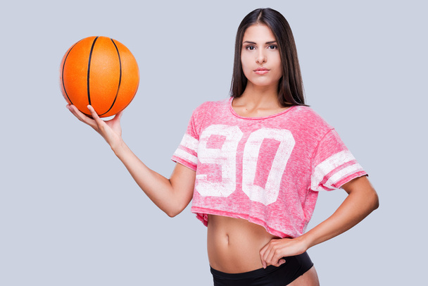 Woman cheerleader holding basketball ball - Foto, imagen