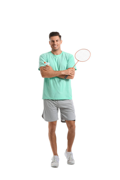 Sporty male badminton player on white background - Foto, afbeelding