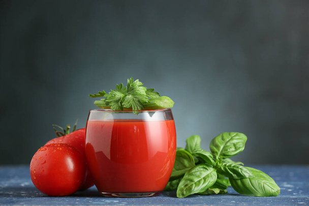 Glass of tasty tomato juice on dark background - Photo, Image