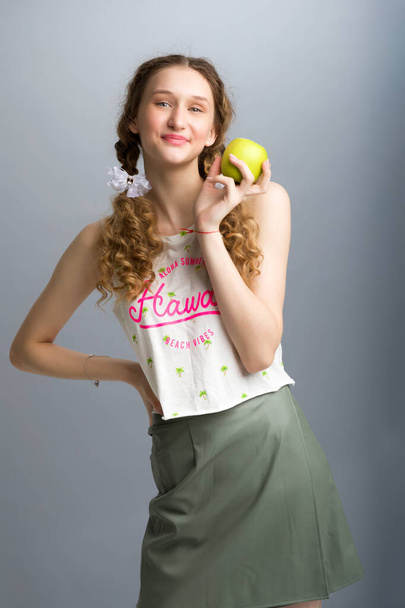 Close up portrait of happy girl t with green apple - Фото, зображення
