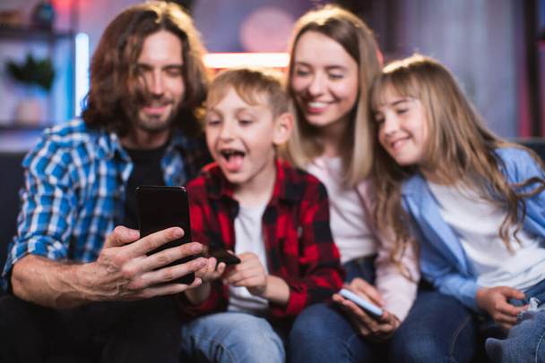 Playful kids and their parents taking selfie on cell phone - Fotoğraf, Görsel
