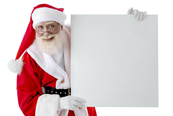 Santa Claus with whiteboard for copy space, mock up on white background isolated. Senior male actor old man with a real white beard in the role of Father Christmas - Photo, Image