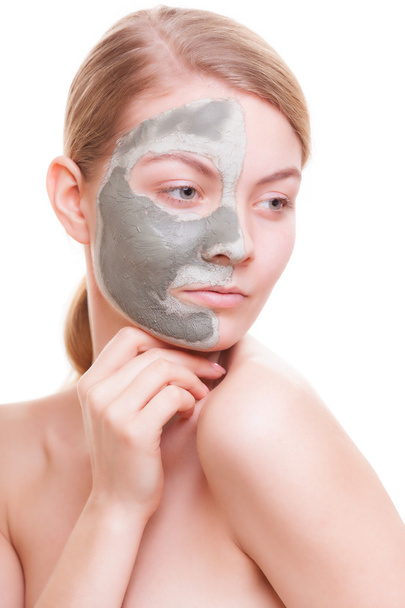 Woman applying clay mask on face. - Zdjęcie, obraz