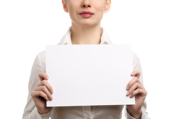 Beautiful businesswoman in a white shirt holding a blank page. Isolated on white background - Photo, Image