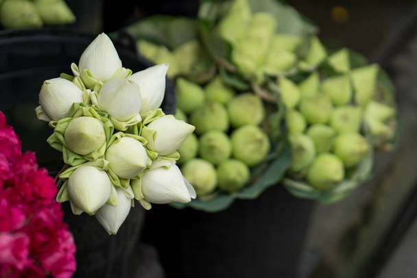 A closeup shot of a beautiful bouquet of white lotuses in the open-air market - Fotó, kép