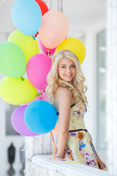 A young woman with large colourful latex balloons - Foto, immagini