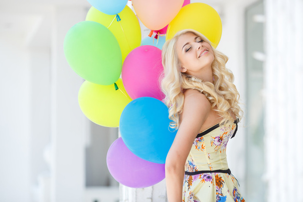 A young woman with large colourful latex balloons - Photo, Image