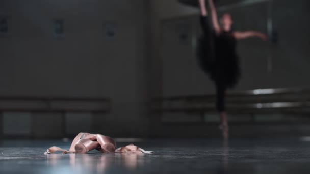 Professionelle Ballerina in schwarzem Tutu beim Tanzen im Studio - Spitzenschuhe im Vordergrund - Filmmaterial, Video