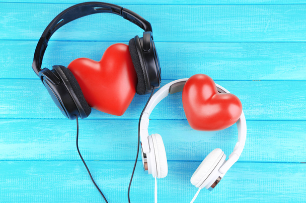 Headphones and hearts on wooden background - Photo, Image