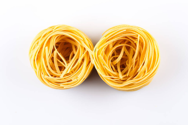 Fettuccine pasta nest isolated on white background - Foto, Imagen