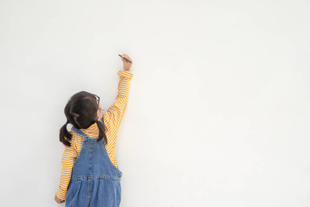 Little children painting on white wall - Photo, Image
