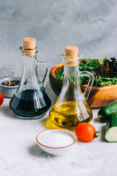 Cooking fresh salad, ingredients on table with olive oil and balsamic vinegar. - Φωτογραφία, εικόνα