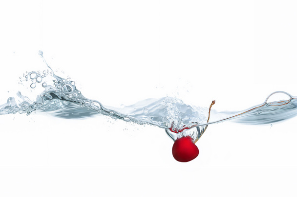 Cherry dropped into water splash on white - Foto, Bild