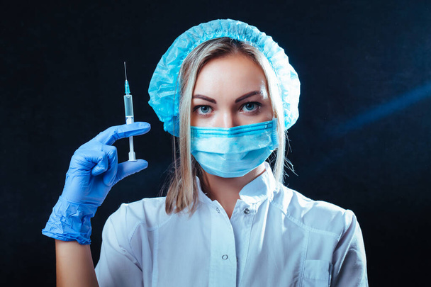 doctor woman holds a syringe in her hand in front of her . concept for medicine and cosmetology - Photo, Image