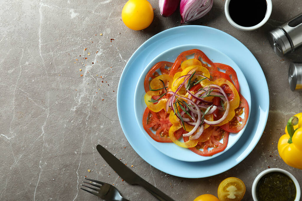 Concept of tasty food with tomato carpaccio on gray textured table - Zdjęcie, obraz