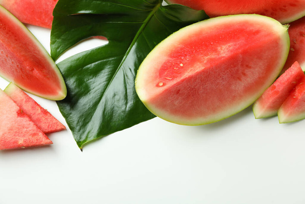Juicy watermelon slices and palm leaf on white background - Photo, Image