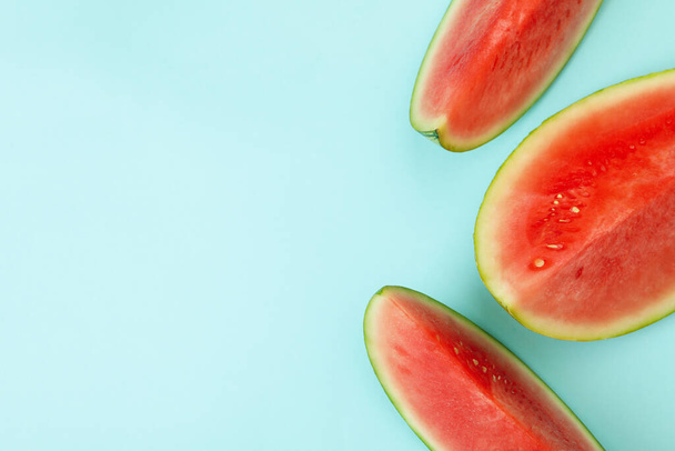 Ripe watermelon slices on blue background, top view - Fotografie, Obrázek