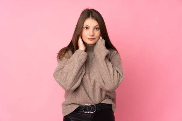 Teenager caucasian girl isolated on pink background frustrated and covering ears - Foto, Bild