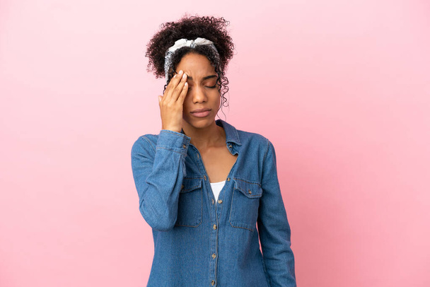 Young latin woman isolated on pink background with headache - Zdjęcie, obraz