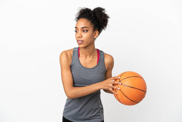 Young basketball player latin woman isolated on white background playing basketball - 写真・画像