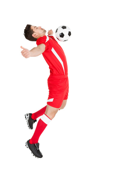 Player Hitting Soccer Ball With Chest - 写真・画像