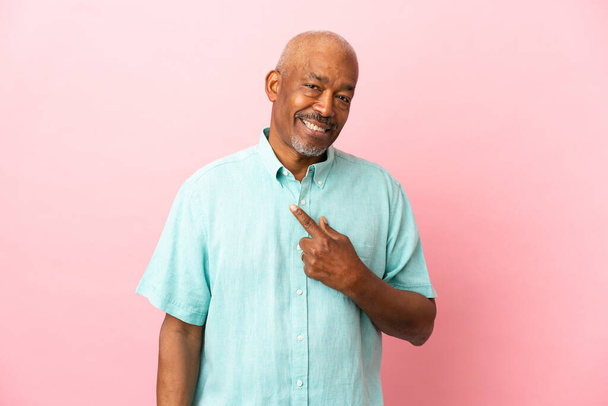 Cuban senior isolated on pink background with surprise facial expression - Photo, Image