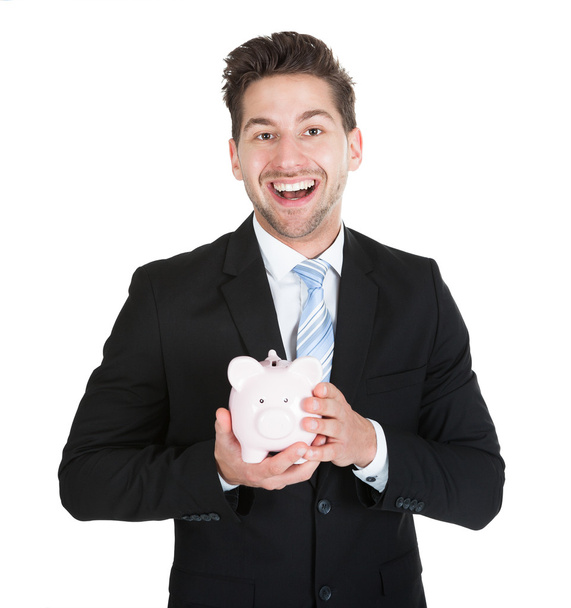 Businessman Holding Piggybank - Foto, immagini