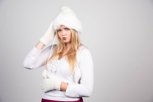 Pretty woman in white hat and white sweater . High quality photo - Photo, Image