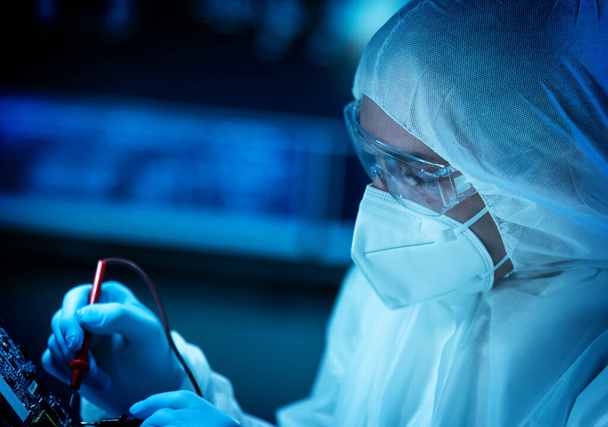 The scientist works in a modern scientific laboratory for the research and development of microelectronics and processors. Microprocessor manufacturing worker uses computer technology and equipment. - Photo, image