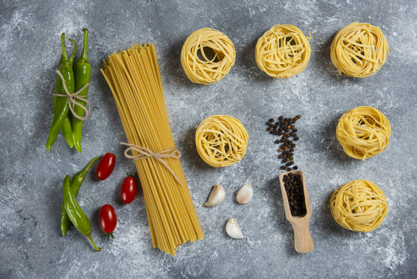 Raw nest pasta with spices and vegetables. High quality photo - Photo, Image
