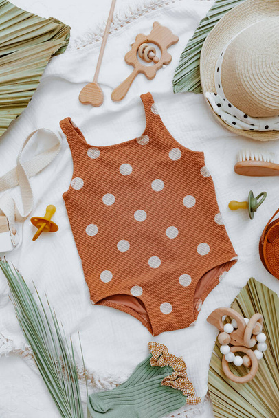 Baby summer background, Flat lay vintage child swimsuit and accessories. Summer kids holiday concept, top view, flat lay  - Zdjęcie, obraz