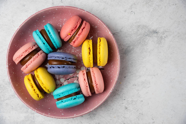 Plate of colorful pastel macarons on white background. High quality photo - Photo, Image