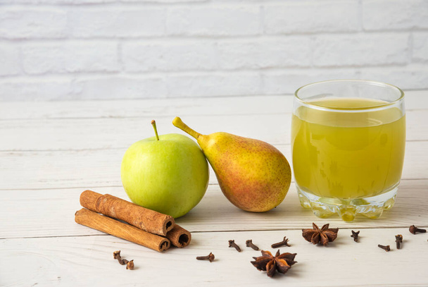 apple cider with cinnamon and anise on wooden background - Photo, Image