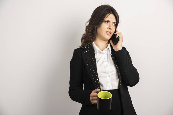 Woman office worker discussing work over telephone. High quality photo - Foto, Imagem