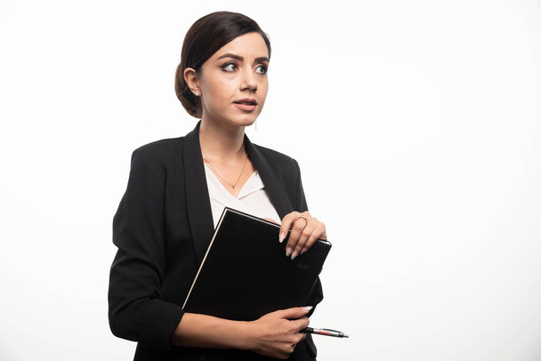 Portrait of businesswoman with notebook and pencil. High quality photo - Zdjęcie, obraz