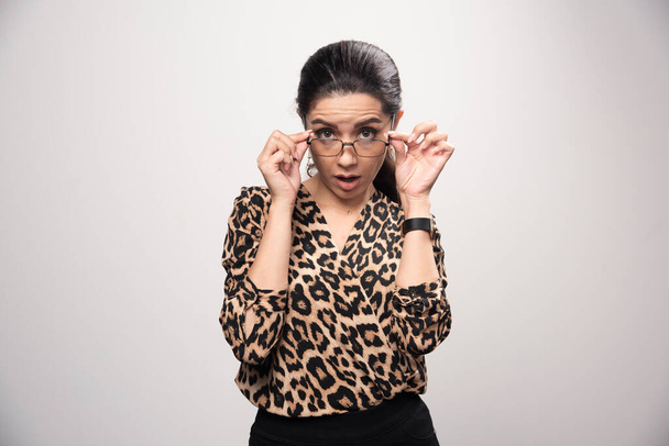 Girl in leopard printed shirt positively surprized and excited. High quality photo - Photo, Image