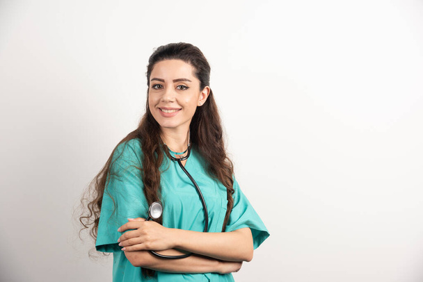 Portrait of female healthcare worker posing with crossed hands. High quality photo - Фото, изображение