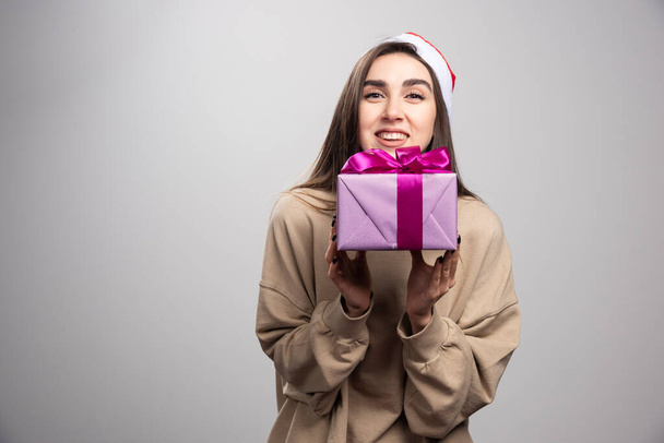 Smiling woman holding a box of Christmas present. High quality photo - Photo, Image