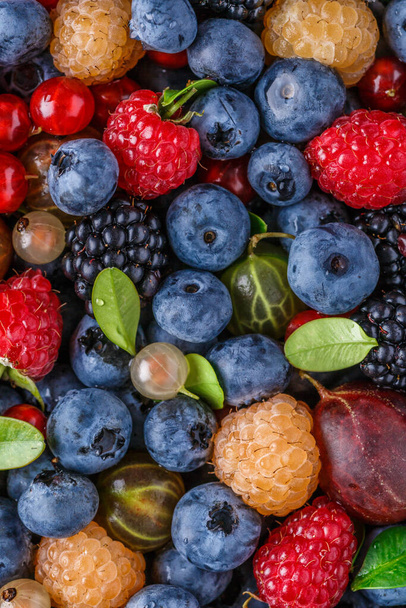 Water drops on ripe sweet blueberry.Vegan and vegetarian concept. Macro texture of blueberry berries.Cranberry in water.Juicy bright cherry and sweet cherry in water, - 写真・画像