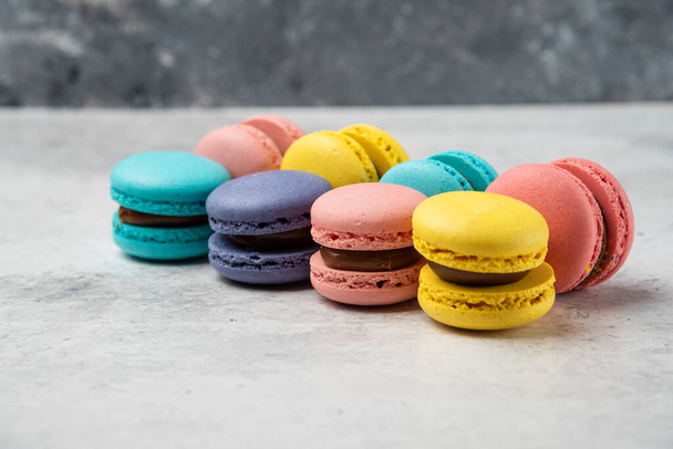 Colorful pastel almond macarons on white table. High quality photo - Photo, Image