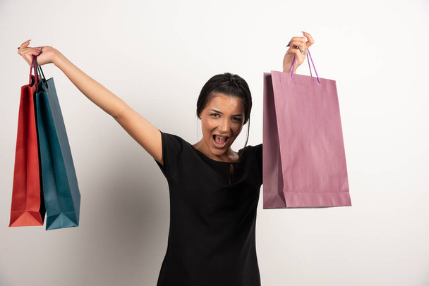 Pretty woman with shopping bags feeling happy. High quality photo - Фото, зображення