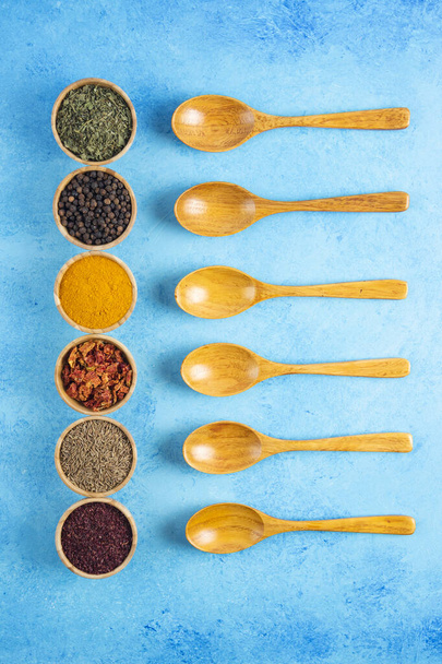 Vertical photo of various kinds of herbs spices over blue background. High quality photo - Photo, Image