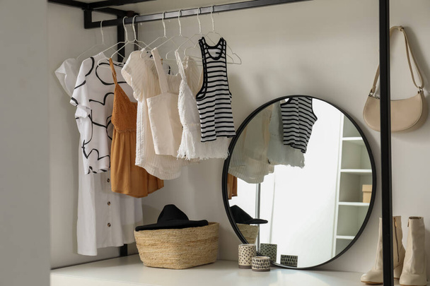 Storage rack with stylish women's clothes and accessories indoors - Fotografie, Obrázek