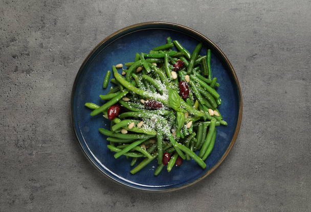 Plate of tasty salad with green beans on grey table, top view - Fotoğraf, Görsel