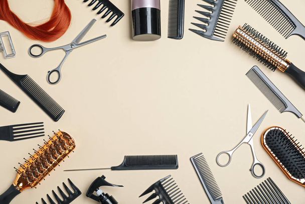 Flat lay composition of professional scissors, hair strand and other hairdresser's equipment on beige background, space for text. Haircut tool - Fotoğraf, Görsel