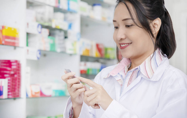Portrait of happy friendly pharmacists working in modern farmacy - Photo, Image
