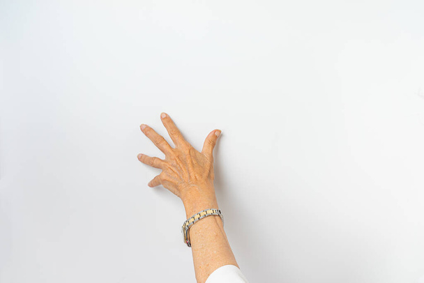 An elder female hand on a white background - Foto, imagen