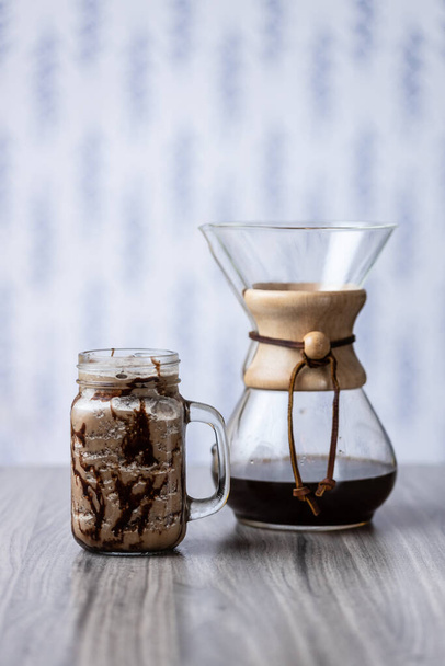 A closeup shot of Chemex with cold coffee on a table - Foto, immagini